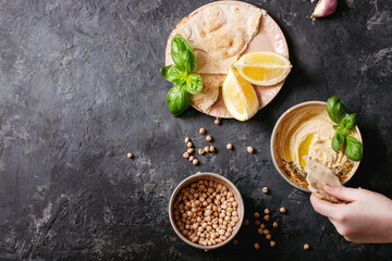 Obraz na płótnie Canvas Hummus with olive oil and ground cumin