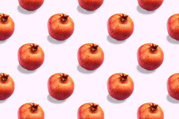 Seamless pattern of ripe red healthy pomegranates on a light background