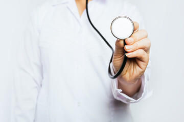 Stethoscope in the hands of a doctor on a light background. The concept of health and medicine.