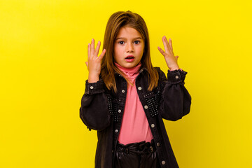 Little caucasian girl isolated on yellow background showing number ten with hands.