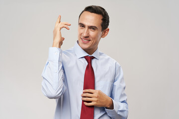 businessman in shirt and tie shows his hand up on a light background financial manager model work
