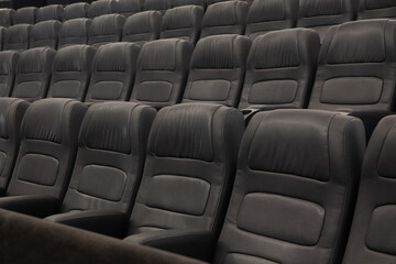 Empty Black Leather Seats In Row At Movie Theater