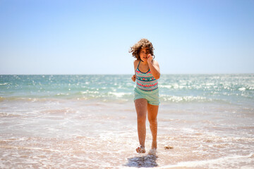 Girl running on the beach.