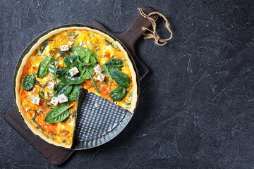 feta spinach parmesan quiche in a baking dish