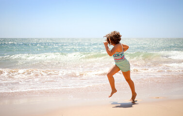 Girl running on the beach.