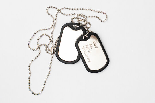 dog tag, army chains, army badge on the light background.