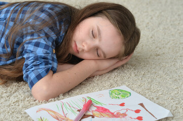 Beautiful girl sleeping on the floor at home