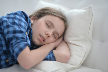 Fototapeta premium Cute little girl sleeping in bed at home