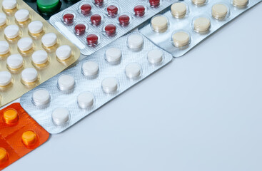 Different pills, tablet's blisters and capsules on white background. Pharmacalogical concept