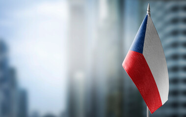 A small flag of Czechia on the background of a blurred background