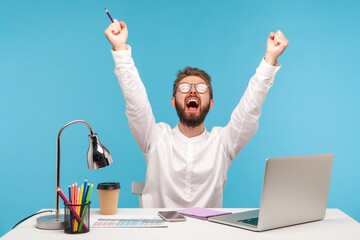 Very excited man with beard office worker screaming eureka raising hands up, solving hard task, getting access, successfully completing work. Indoor studio shot isolated on blue background - obrazy, fototapety, plakaty