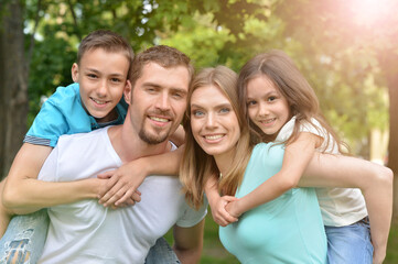 Portrait of happy young family in summer  park