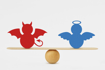 Devil and angel on balance scale - Balance between good and evil - 430152223