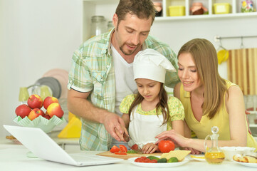 family cooking together at kitchen table