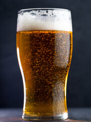 Close-up of a pint glass of light lager beer