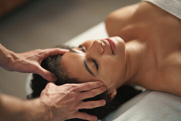 Fototapeta na wymiar Young woman having head massage at the spa.