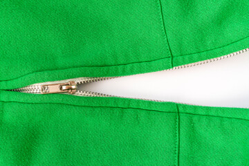 Unzipped zipper on a green sweater.Close up. © graja