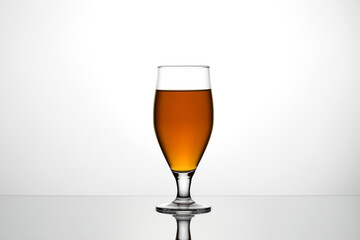 Glass of cuba libre or long islan iced tea on white background.