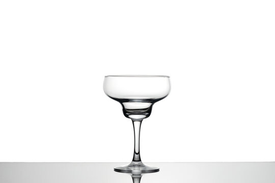recommend clip art: Empty cocktail glass with reflection on white background. Margarita glass. 