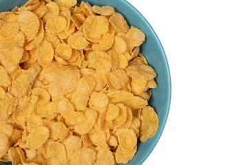 Cornflakes in a blue cup. Close-up. View from above. Isolated on white background. Copy space.