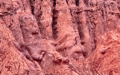Close up of a natural, strongly eroded rock wall in the Cerro de los Siete Colores, Quebrada de Purmamarca, nortwest Argentina