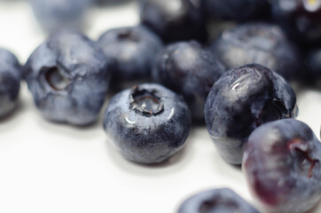 Closeup on fresh and ripe blueberries on a white background