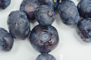 Closeup on fresh and ripe blueberries on a white background