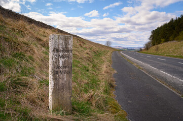 Milestone north near Otterburn on A696, where there are several ancient marker posts on the rural...