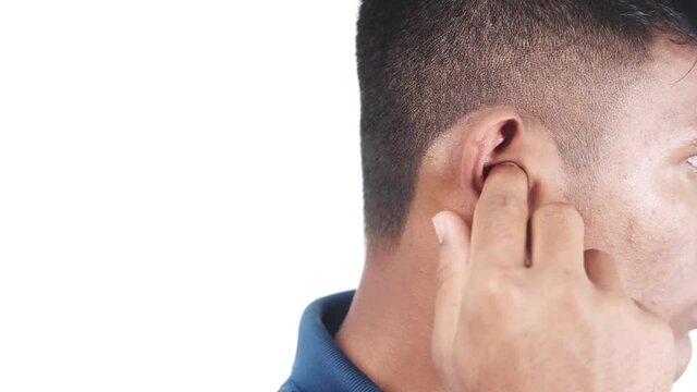 young man rubbing ears suffering from noise 