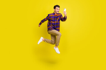 Full length profile side photo of young man happy positive smile jump up make selfie cellphone...