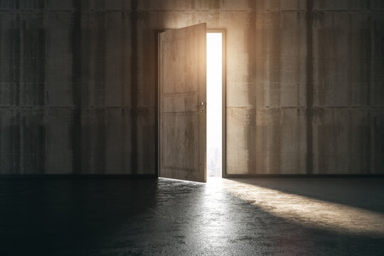 Business ventures and initiatives concept with bright sunlight falling on concrete floor from opened door in wooden wall