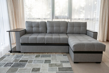 Modern interior with big sofa and a large windows