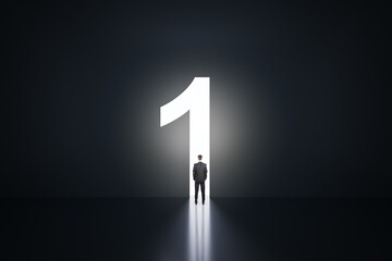 Businessman silhouette in a number one shaped doorway, dark room. Success and leadership concept
