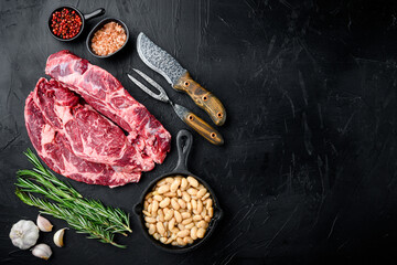 Rib eye ingredients with beans, on black stone background, top view flat lay, with copy space for text