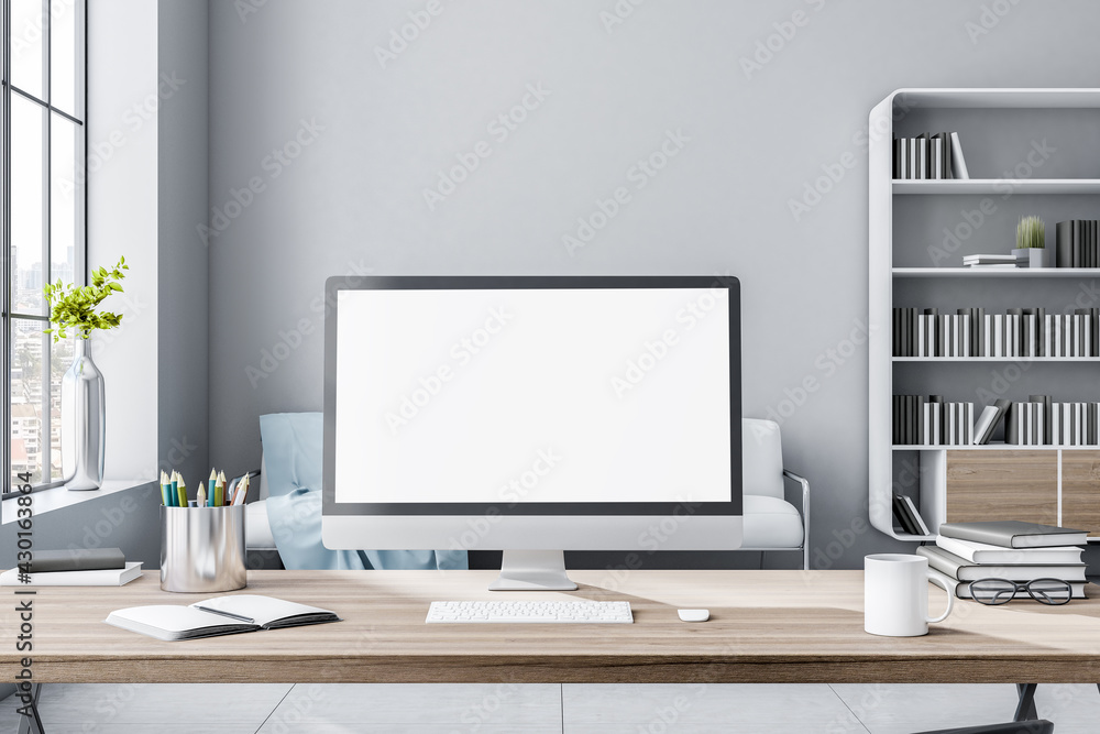Leinwandbilder blank white computer monitor on eco style wooden workspace table in sunny light room with huge windo