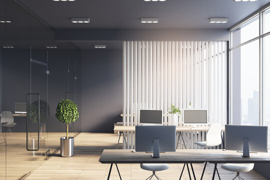 Monochrome style office hall with white wooden slatted partition between workspaces, dark ceiling and wall and big window with city view