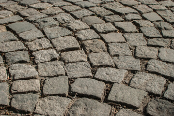 Stone paving roadway surface closeup as stone background