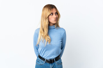 Young blonde Uruguayan woman over isolated background and looking up