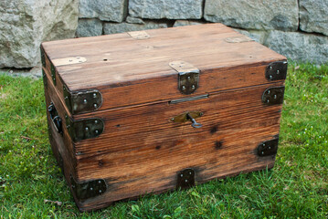 Old retro vintage wooden chest on house garden closeup