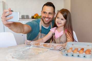 Happy Dad And Daughter Making Selfie Baking Cookies In Kitchen