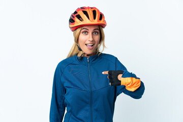 Young blonde Uruguayan cyclist woman isolated on background with surprise facial expression