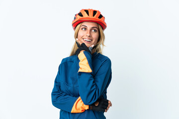 Young blonde Uruguayan cyclist woman isolated on background happy and smiling