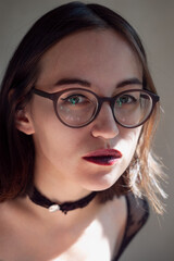 Fototapeta premium Portrait of woman in the round glasses with natural lighting