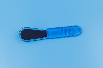 Blue pedicure grater on blue background