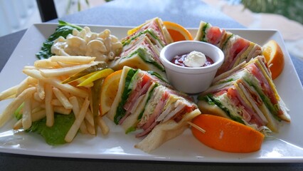 Club Sandwich with catsup and mayonnaise dip