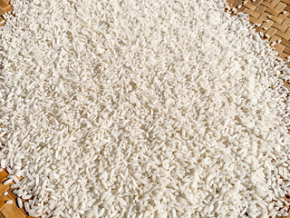 rice in a rattan winnowing basket tray.