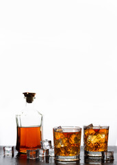 Golden whiskey in glass with ice cubes