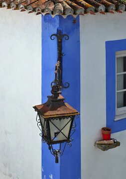 Traditional house facae in Portugal with metal lantern 