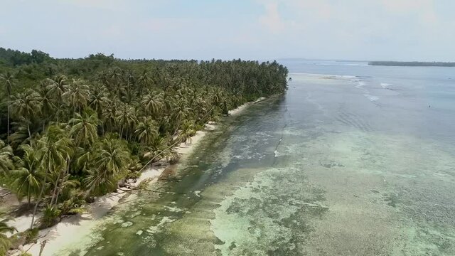 Wild islands of Indonesia. Sumatra. tropical paradise. Telos, Banyak, Mentawai. drone shooting. Wild beaches, blue lagoons, coral reefs, green hills. aerial view. High quality 4k footage