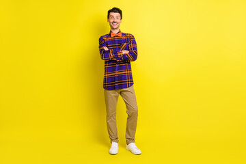 Fototapeta na wymiar Full size photo of young happy smiling positive confident businessman with folded arms isolated on yellow color background